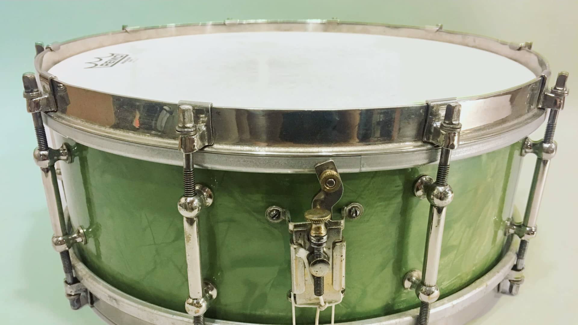 A vintage, green acoustic snare