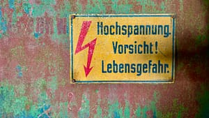 feature image rusty German high voltage sign
